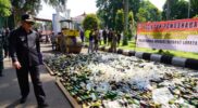 Bupati Garut, Rudy Gunawan, menunjukkan botol miras yang akan dimusnahkan oleh jajaran Pemda Garut di Area Gedung Pendopo Garut, Kecamatan Garut Kota, Kabupaten Garut, Senin (17/04/2023). (Foto : Deni Seftiana & M. Sofyan Fauzil/Diskominfo Garut).